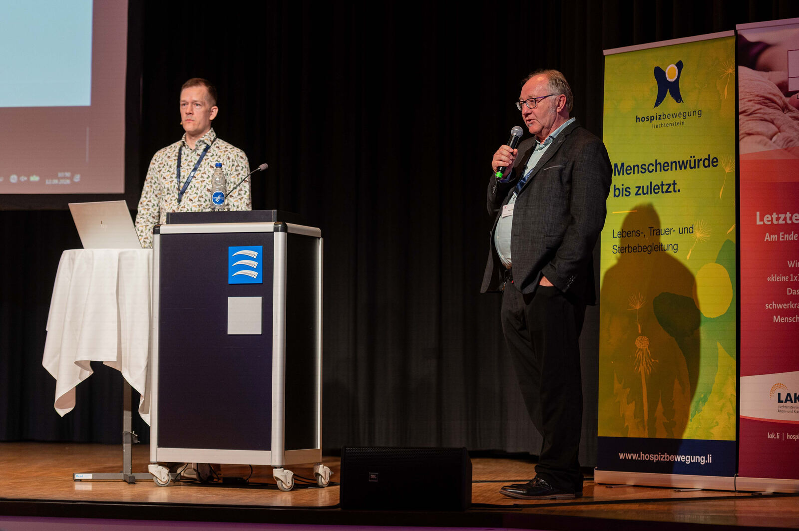 Mathias at the lectern next to another speaker